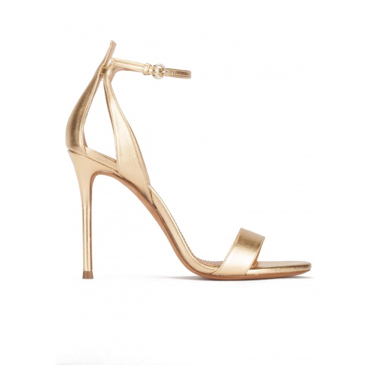 Ankle-strap high heeled sandals in gold metallic leather Pura López